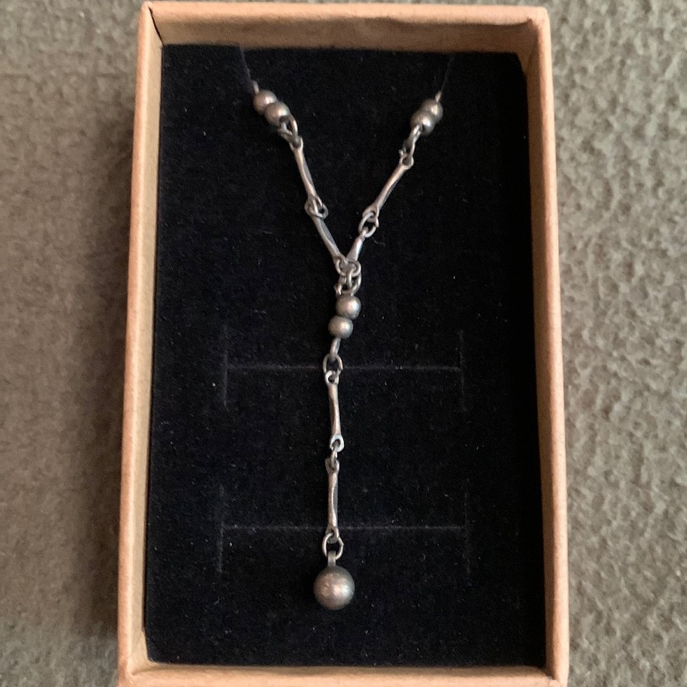 Claire’s vintage look silver necklace.  Adjustable size.